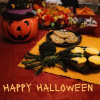 table set for a happy halloween with tricks and treats