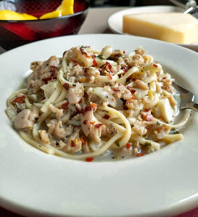 clam sauce over linguini with red pepper flakes served