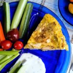 potato and onion egg frittata served on blue glass plate