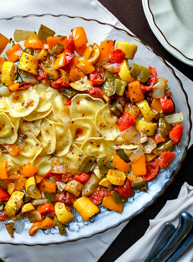 ravioli with roasted vegetables sweet peppers onion plum tomato summer squash roasted in a balsamic olive oil herb dressing