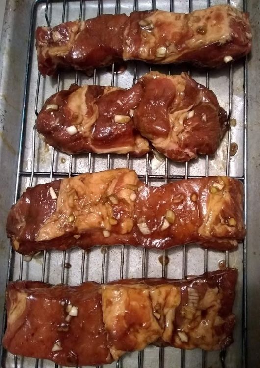 boneless pork ribs on baking rack ready for oven