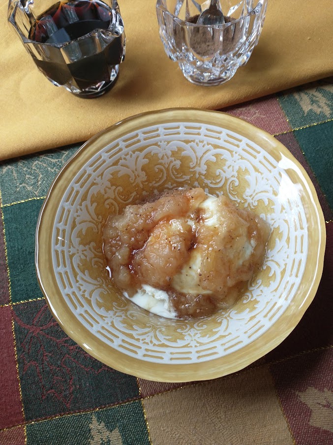 a sundae make with homemade applesauce vanilla ice cream maple syrup and nutmeg