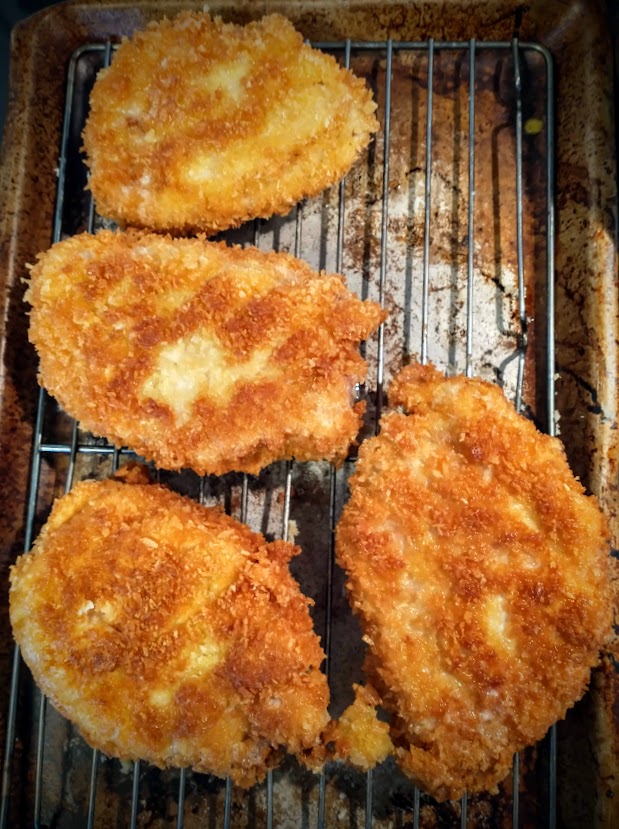 breaded cutlets with a crispy crust on a rack after frying