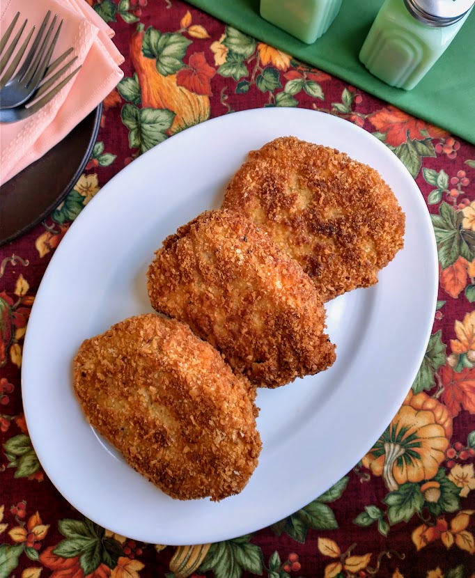 panko crusted pork cutlets on white serving platter