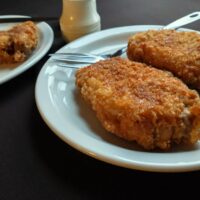 golden fried pork cutlets with a thick crispy crust served