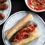 italian sausage covered with sauteed red pepper and onion on french bread