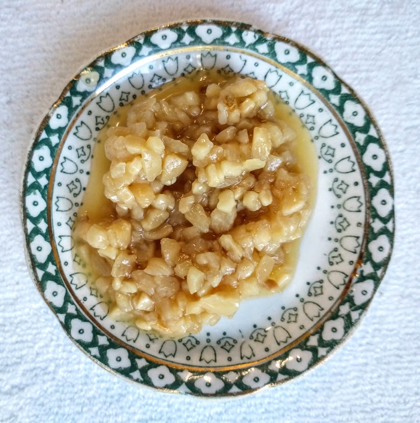 a small plate with minced jarred fresh garlic