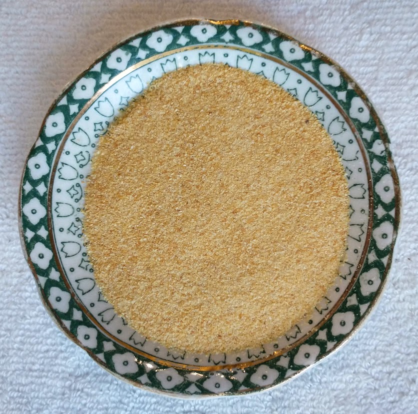 a small dish with granulated garlic powder