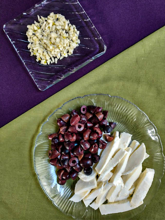 chopped garlic sliced kalamata olives and sliced mozzarella cheese