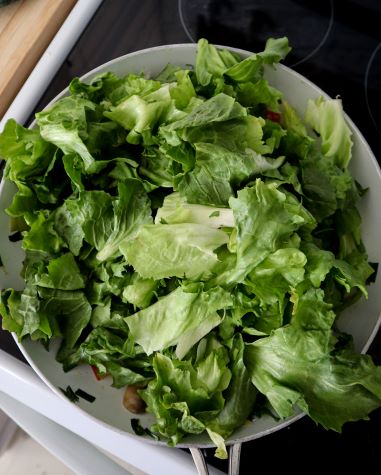 skillet mounded with escarole leaves