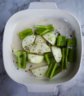 liquid and thyme added to onion and celery