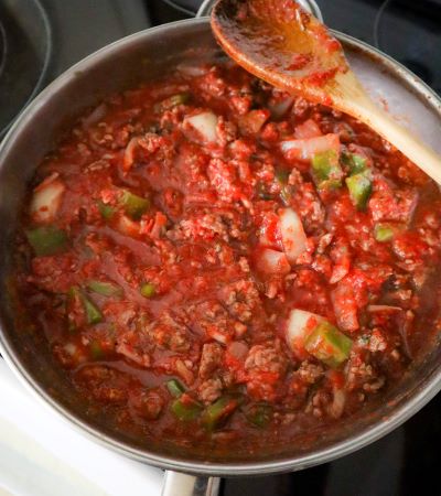 american chop suey ingredients mixed up in skillet ready to cook