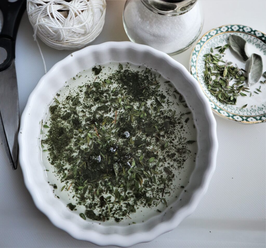 close up of dried herbs crushed up in oil