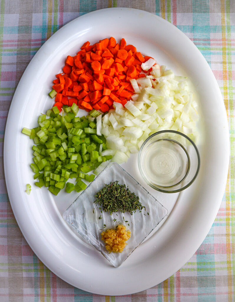 chopped celery onion and carrot with a small  cup with wine ground thyme and chopped garlic