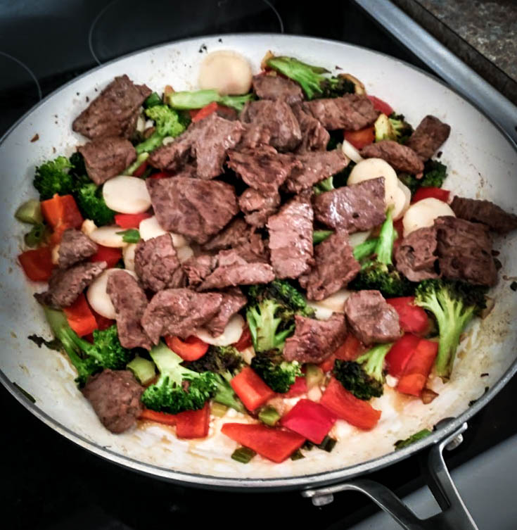 beef added to the mix of cooked vegetables