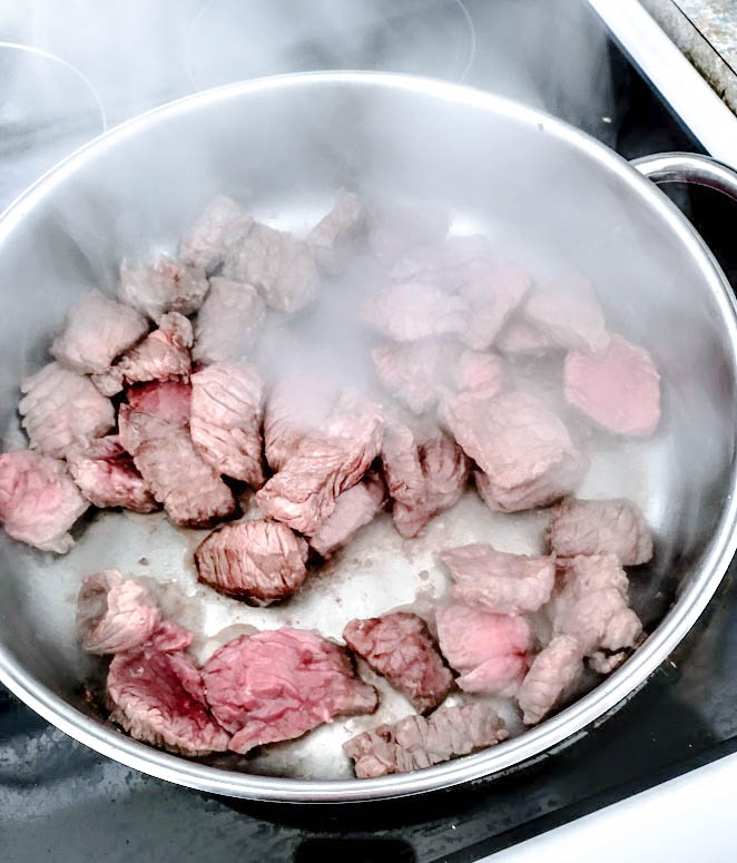 pieces of beef frying at a high temperature