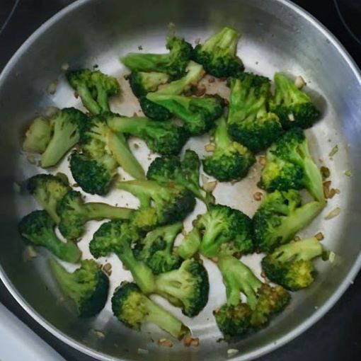 broccoli and minced garlic cooked in oil in skillet