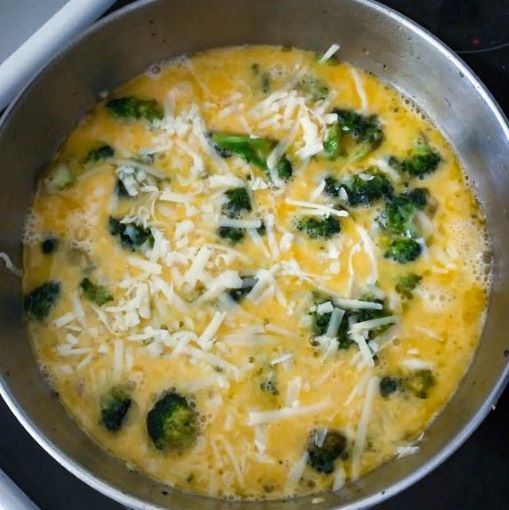 grated cheddar cheese added over the top of the eggs in the skillet