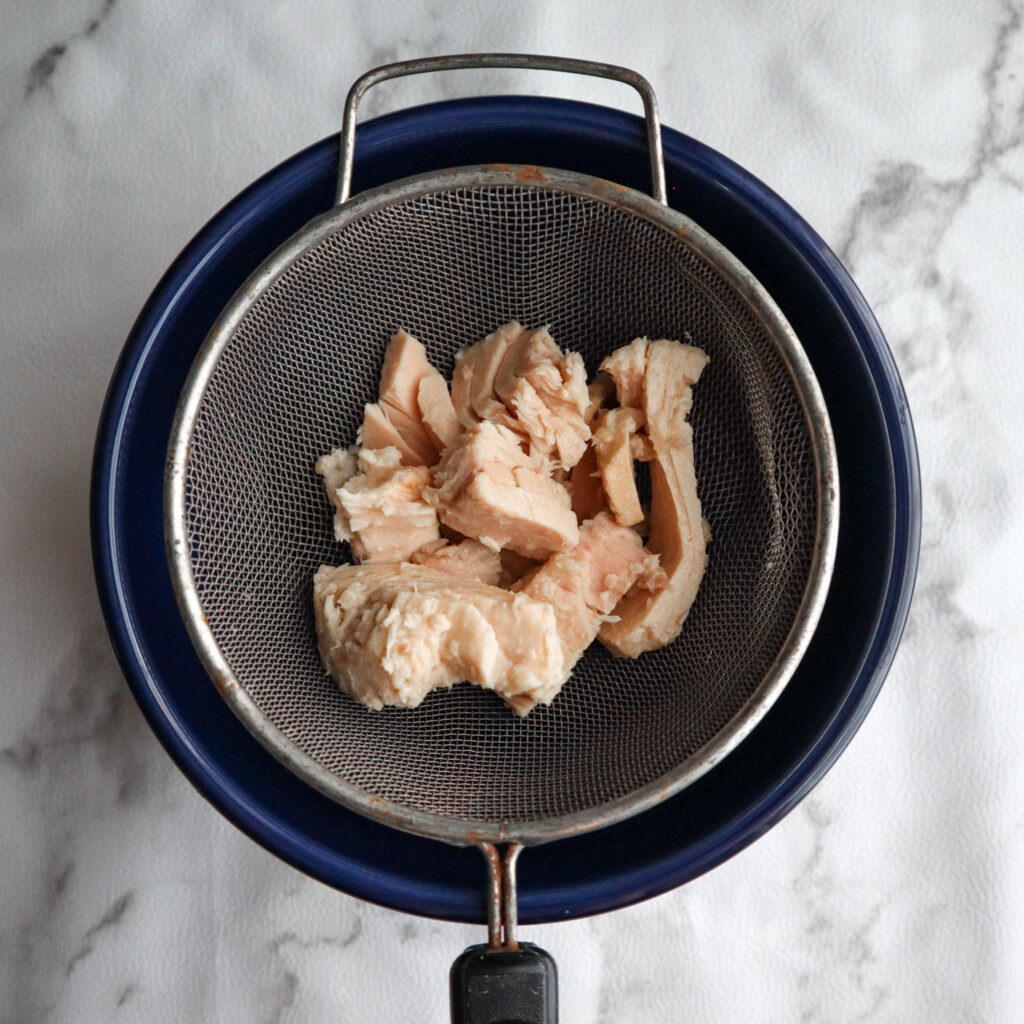 tuna from the can still in chunks in the strainer