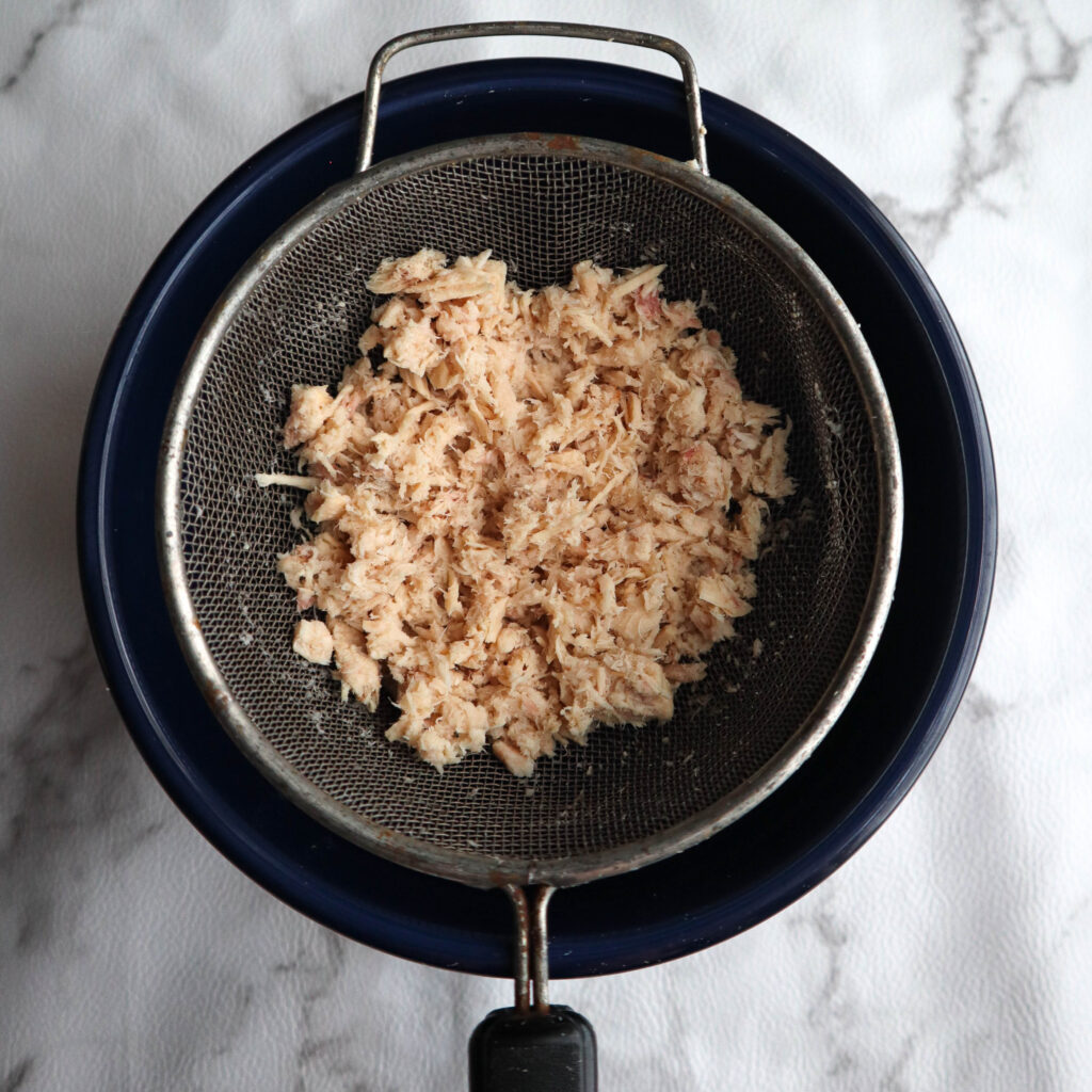 tuna with all the moisture squeezed out in the strainer