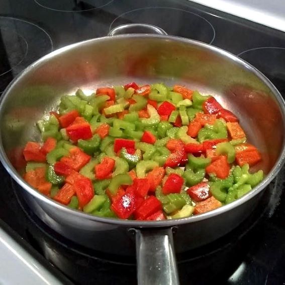 celery and red pepper sautéing in skillet