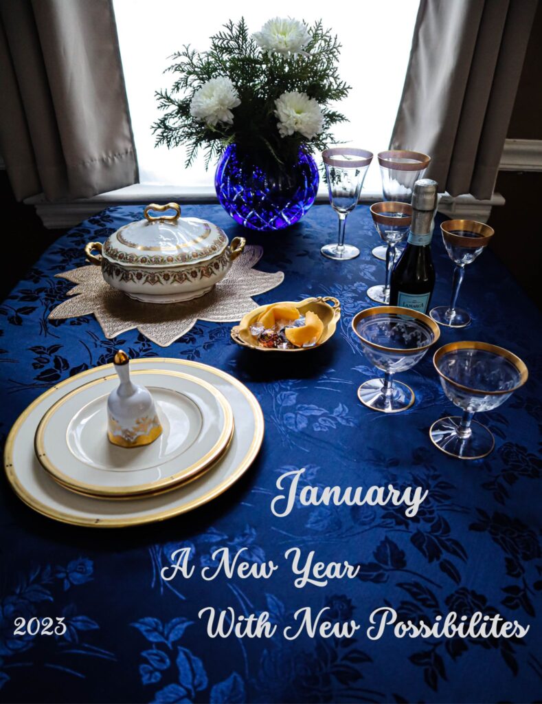 january table setting in royal blue and white with gold trimmed dishware and stemware