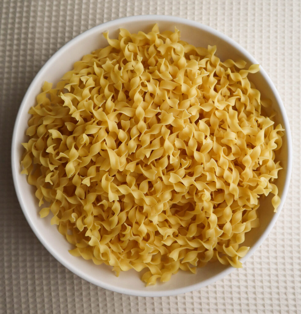 uncooked egg noodles in a bowl