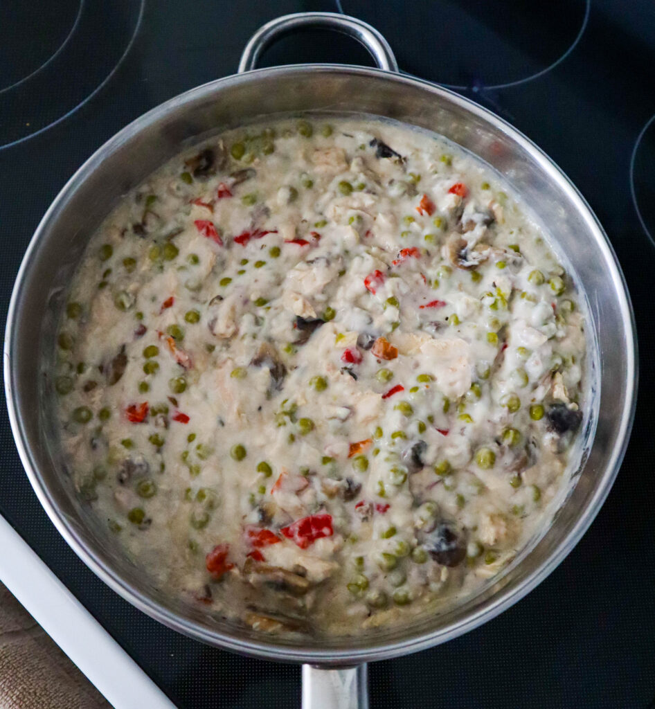 adding the cream of mushroom soup to the skillet