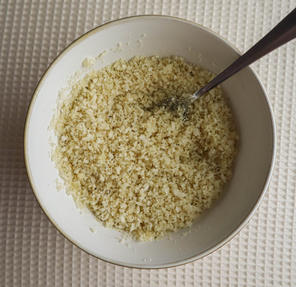 a small bowl with panko crumbs and melted butter