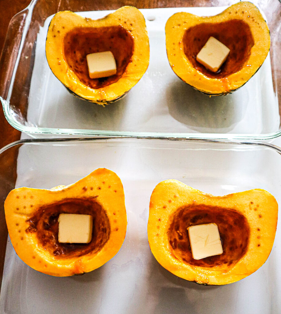 small acorn squash with brown sugar and butter ready to go in the oven