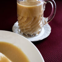 picture of chicken gravy on dark red tablecloth