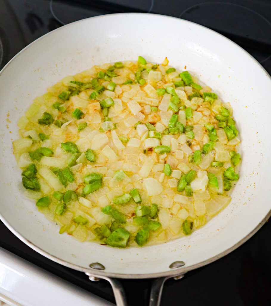 sauteed onion and celery in a skillet