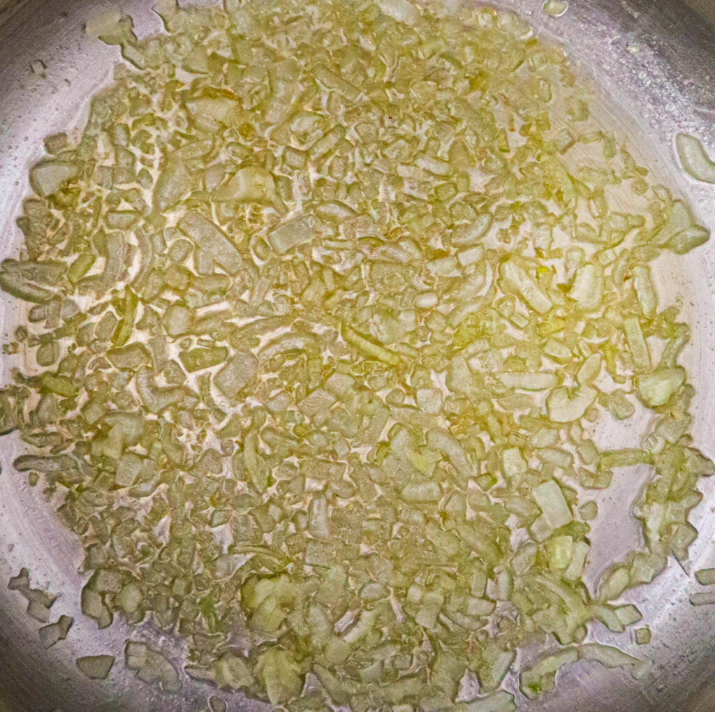 minced onion cooking in melted butter
