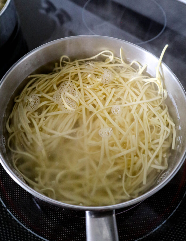 a saucepan with fresh pasta boiling in water
