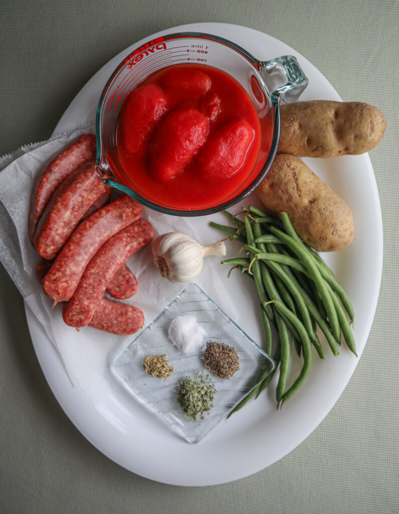 italian sausage stew ingredients canned tomatoes potatoes green beans sausages garlic and spices