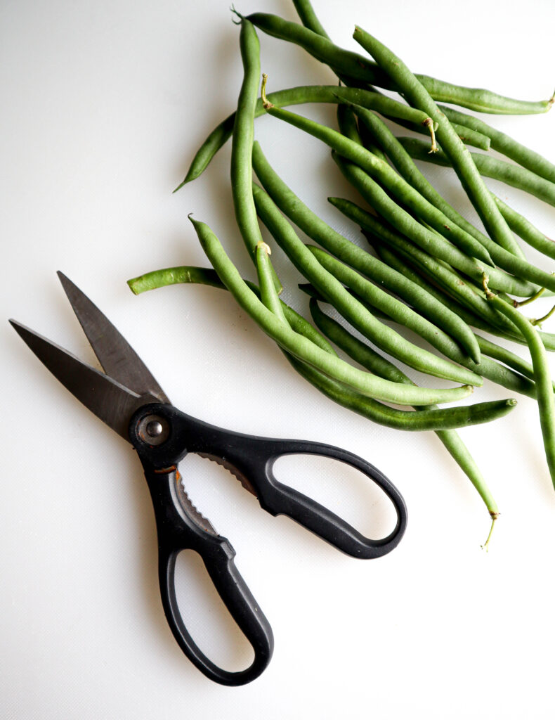 green string beans and a pair of kitchen shears