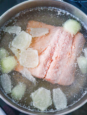 poached salmon and onion in skillet