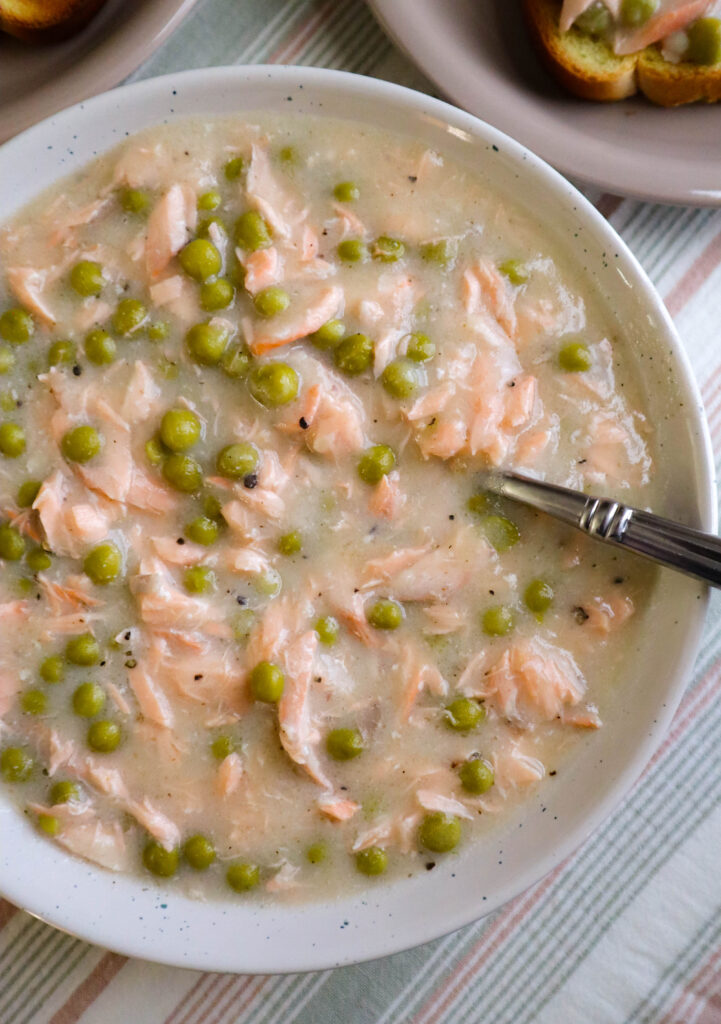 serving bowl of creamed salmon and peas served over toast