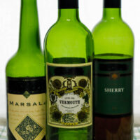 a bottle of vermouth a bottle of marsala and a bottle of sherry all used for cooking
