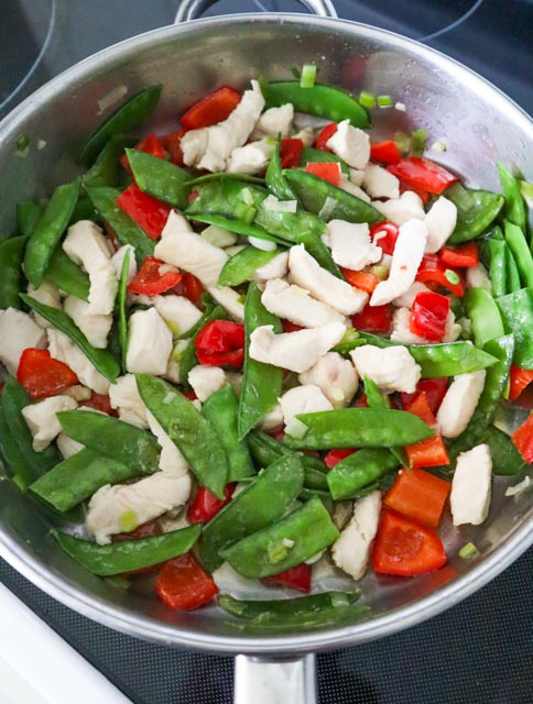 cooked chicken mixed in with vegetables