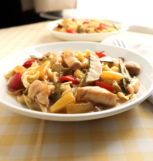 chicken pineapple stir fry on single serving plate side view