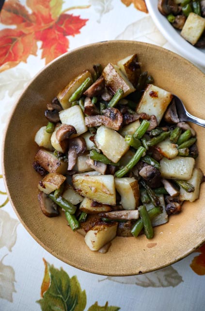 potato mushroom and green bean saute served family style in a bowl