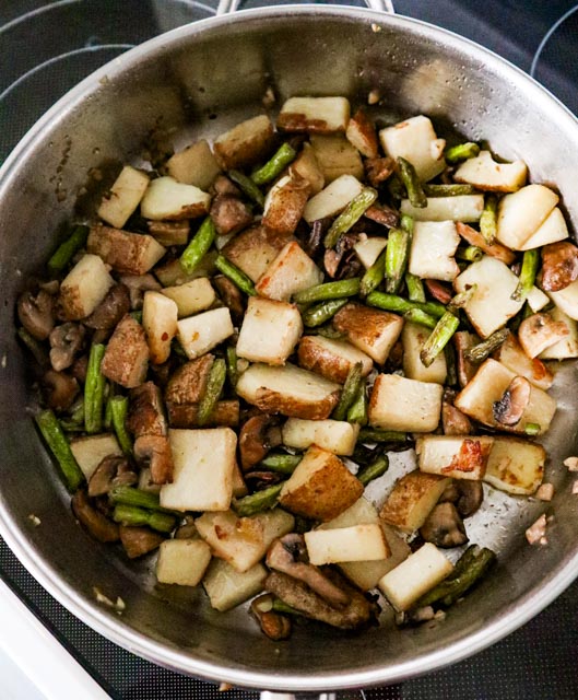 mushrooms green beans and potatoes suateed in skillet