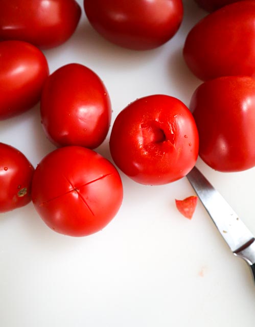 plum tomatoes that are scored and cored