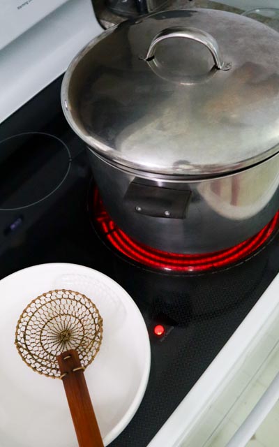 setting up for blanching with a large pot and a dish 