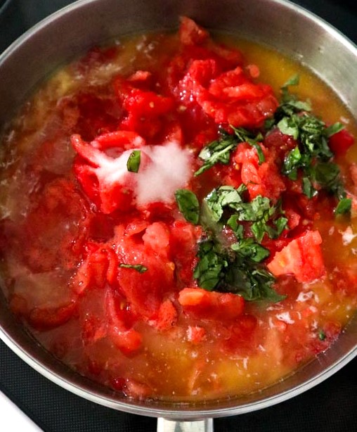 hand crushed tomatoes with basil and salt added to the butter in the skillet