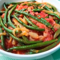 serving bowl with string beans with tomato onion and garlic