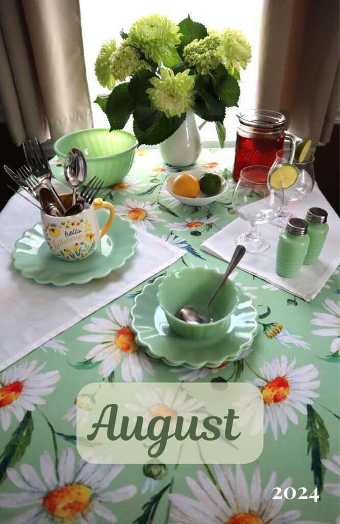 august dinner table big white daisies on light green tablecloth with light green dishes and light green flowers